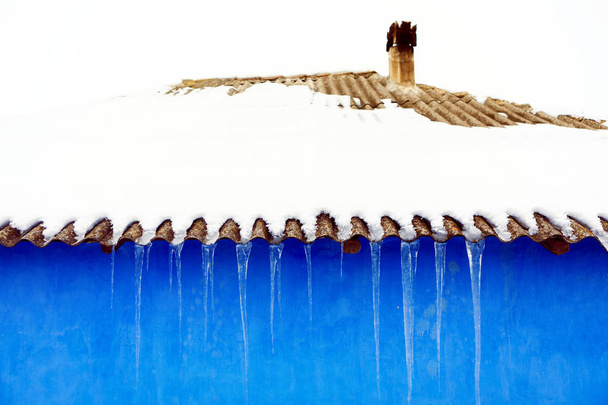 carámbanos y pared azul
 - Foto, imagen
