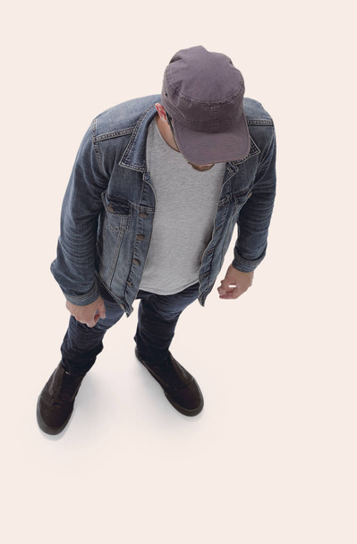 view from above. guy in a baseball cap and denim jacket - 写真・画像