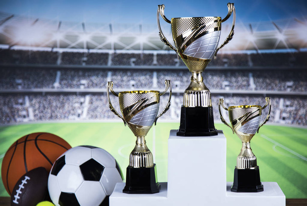 Cups of winners award on white podium, sport background - Photo, Image