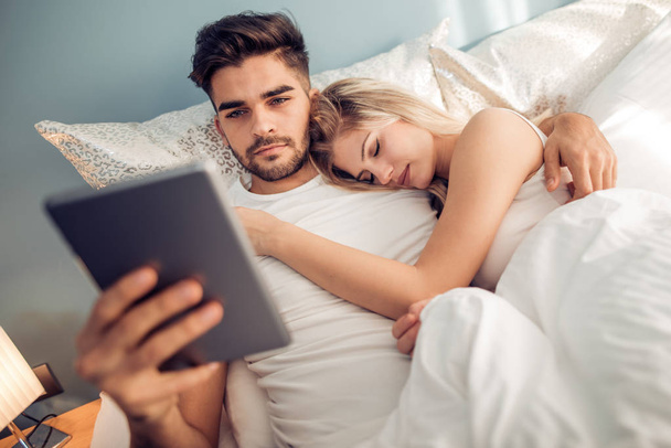 Young couple lying in bedroom - Photo, Image