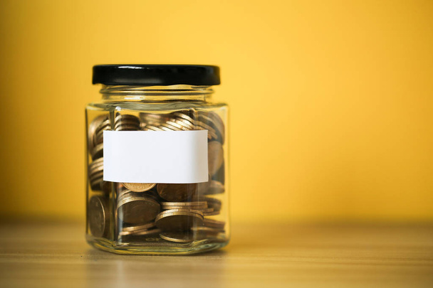 Coins In Glass Money Jar - Фото, изображение