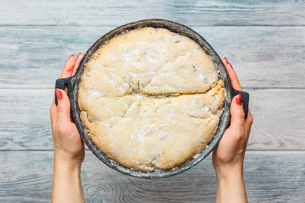pie in a frying pan and in hands. cooking at home - Photo, Image