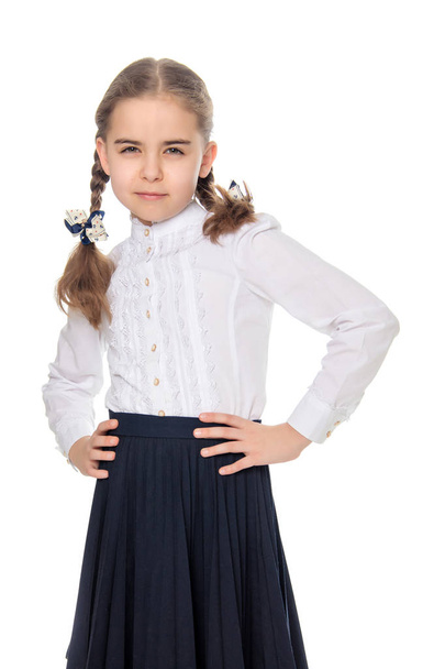 A little girl in a white dress and a dark skirt. - Foto, imagen