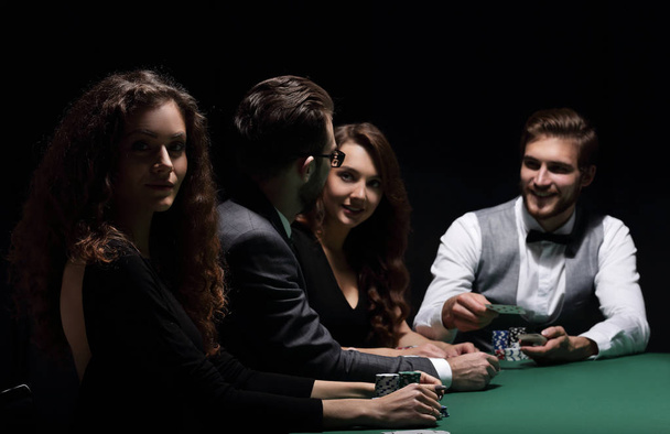 players sitting at the playing table in the casino - Foto, afbeelding