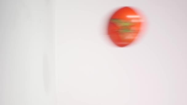 two Half tomato falling on a white background - Filmagem, Vídeo