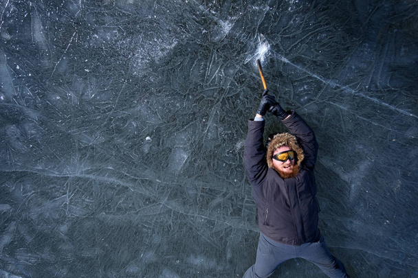 bearded redhead alpinist in protective yellow glasses with ice a - Photo, Image