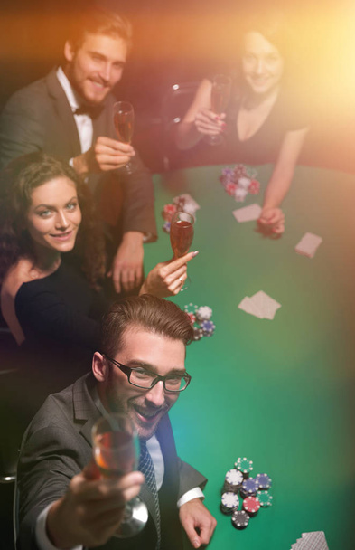 Group of young rich people is playing poker in the casino - Valokuva, kuva