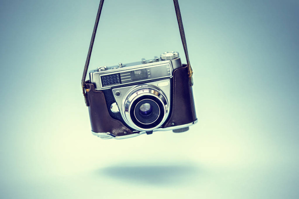 Vintage photo camera on blue background - Фото, изображение