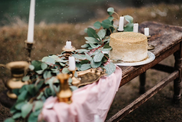 wedding decor with a golden cake - Photo, Image