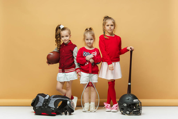 Happy and beautyful children show different sport. Studio fashion concept. Emotions concept. - Fotoğraf, Görsel
