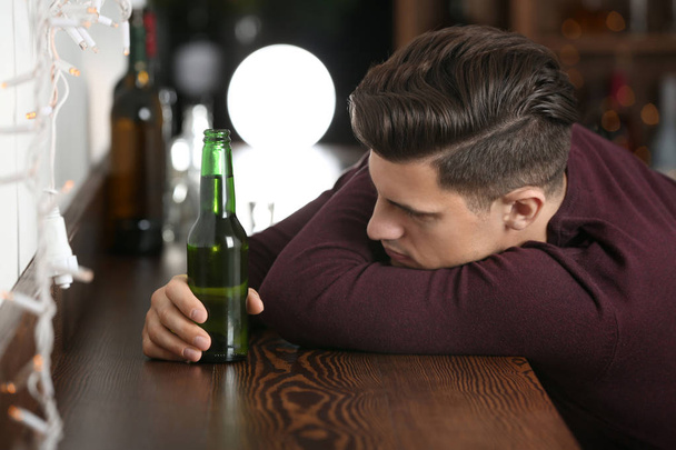 Young man with bottle of beer  - Foto, Imagem