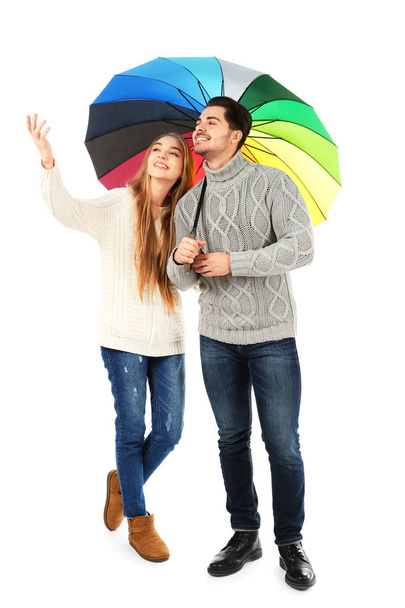 Young couple with colorful umbrella  - Fotó, kép