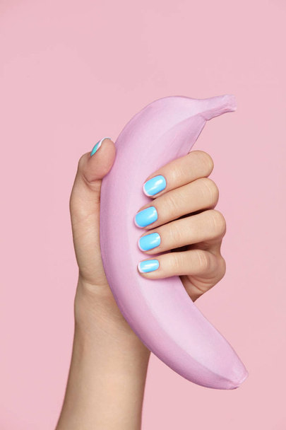 Nails Beauty. Hand With Blue Nails Holding Banana - Fotoğraf, Görsel