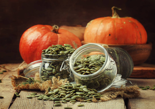 Raw pumpkin seeds, healthy snack, vintage wood background, rustic style, selective focus - Foto, Imagem
