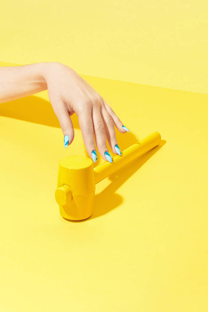 Nails Design. Hand With Colorful Nails On Yellow Background - Valokuva, kuva
