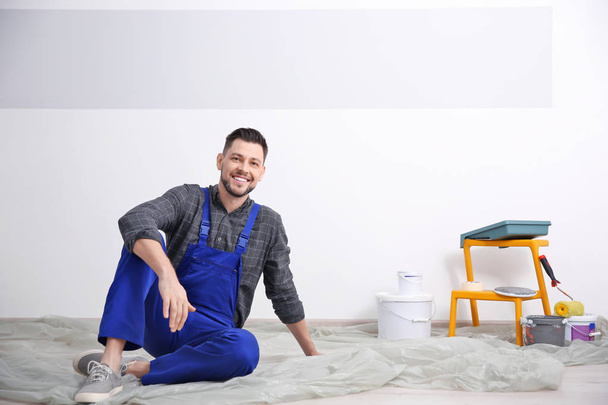Young male decorator on floor in room - Photo, Image