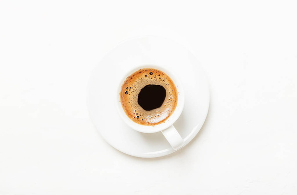 White cup of black coffee espresso with foam, white background, top views - Fotografie, Obrázek