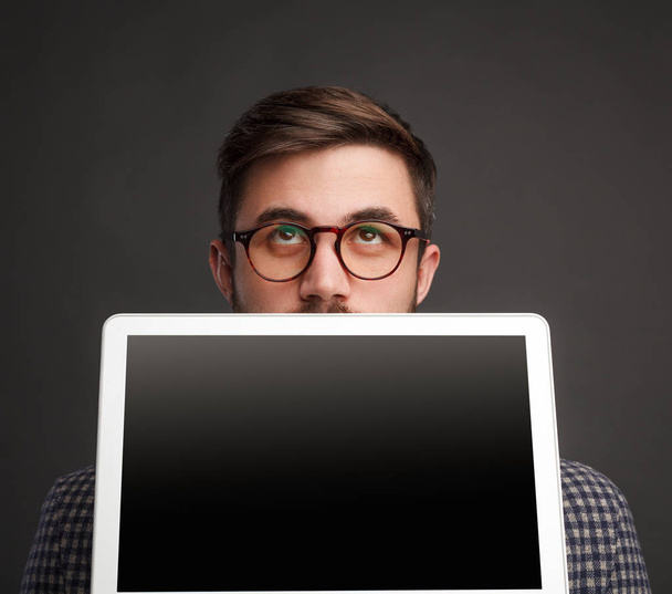 Pensive man showing laptop - Фото, изображение