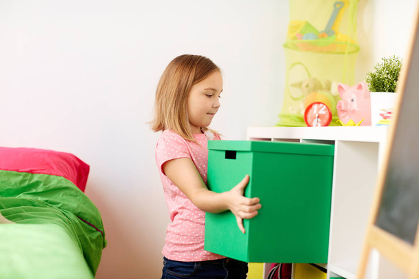 happy little girl with toy box at home - Foto, imagen