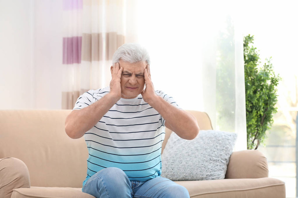Mature man suffering from headache at home - Fotoğraf, Görsel