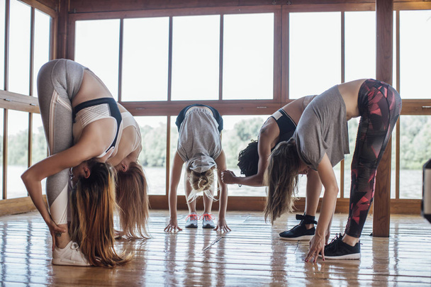 Group of Sportswomen Stretching - Foto, afbeelding