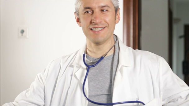 Physician entering consultation room, then moving out of frame - Felvétel, videó