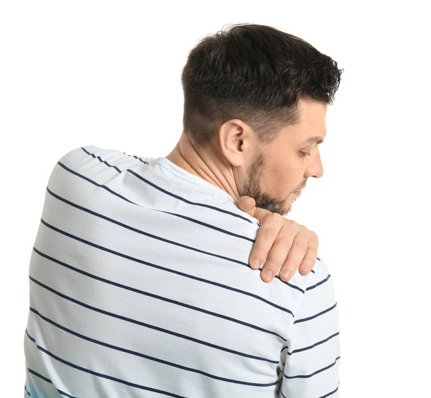 Young man suffering from shoulder pain on white background - Fotó, kép
