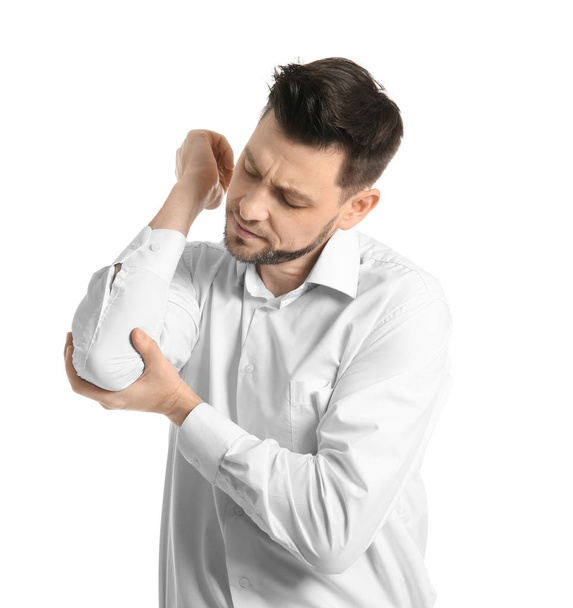 Young man suffering from elbow pain on white background - Photo, image