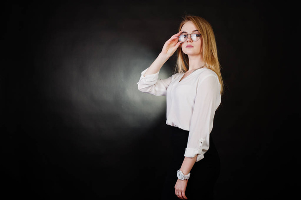 Studio portrait of blonde businesswoman in glasses, white blouse - Photo, image