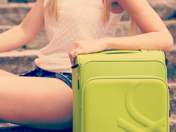 Part body of female tourist with suitcase. - Zdjęcie, obraz