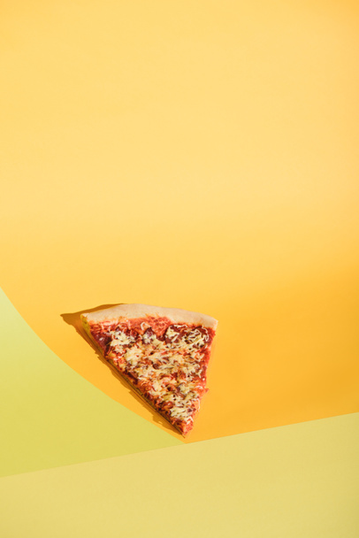 close up view of piece of italian pizza on colorful background - Foto, immagini