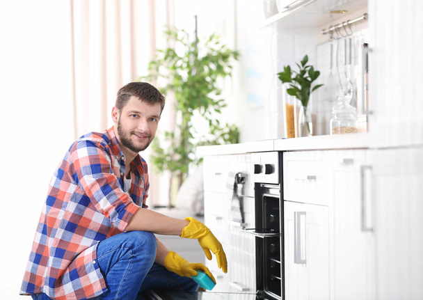 man cleaning oven - Photo, Image