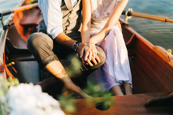 young wedding couple in boat sitting - Zdjęcie, obraz