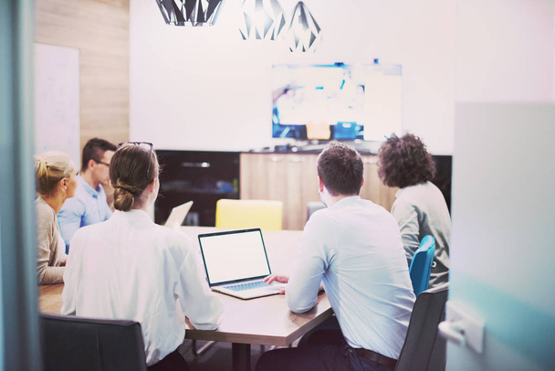 Group of a young business people discussing business plan at modern startup office building - Fotoğraf, Görsel