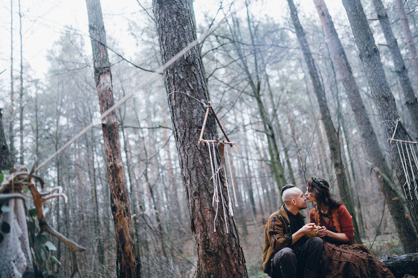 young  guy with his beloved girl eating   in the forest - Photo, Image