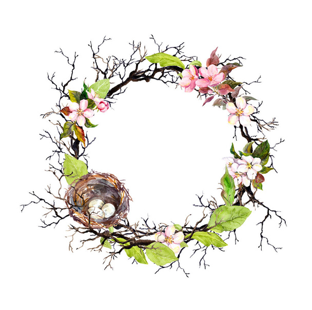 Nest with eggs, spring blossom flowers, branches and green leaves. Floral wreath for Easter. Watercolor circle border - 写真・画像