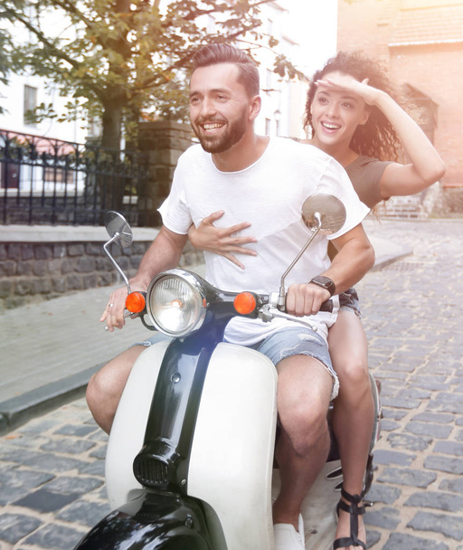 Young couple riding motor scooter in city - Fotografie, Obrázek