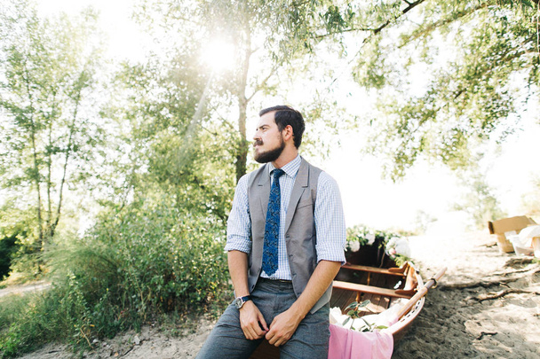 Handsome groom posing near boat outdoors   - Foto, immagini