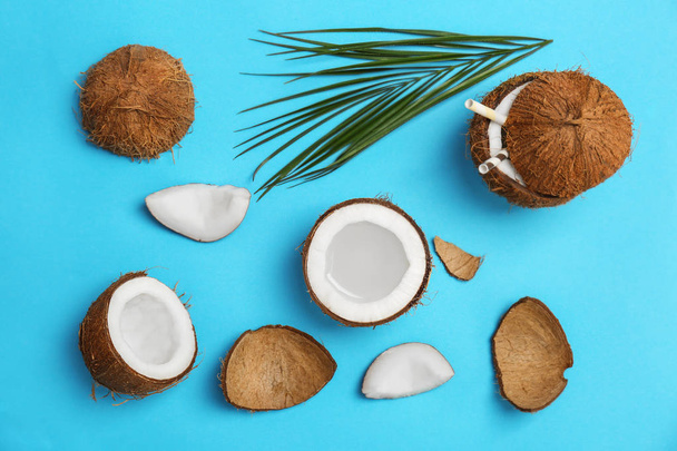 Coconut water and fresh nuts on color background - Φωτογραφία, εικόνα