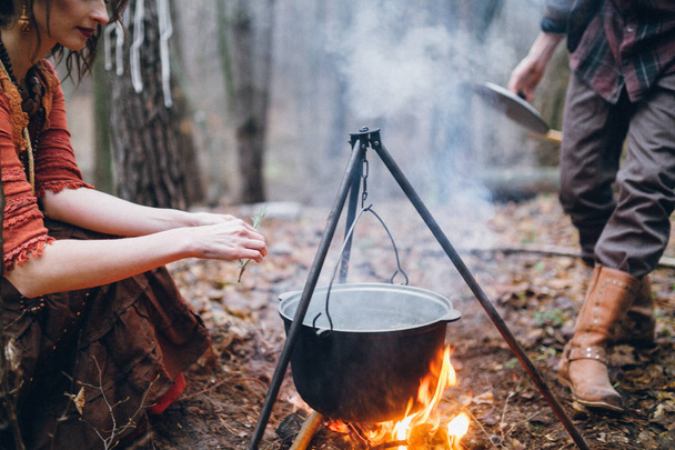  young woman cooking in forest outdoors - Photo, Image