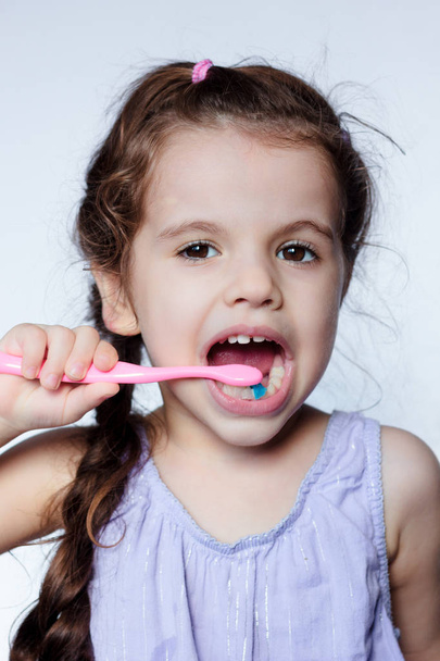 Little kid girl cleaning teeth by toothbrush, dental care concept - Zdjęcie, obraz