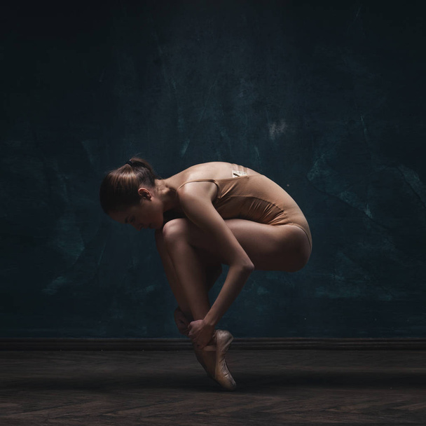 young beautiful ballet dancer in beige swimsuit - Fotó, kép
