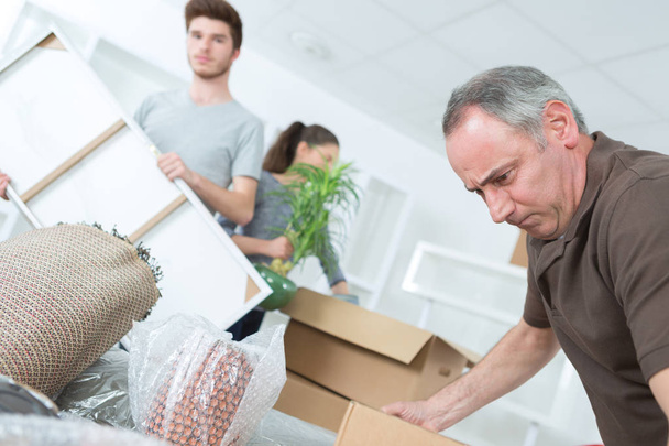 frustrated middle-age man with moving boxes at home - 写真・画像