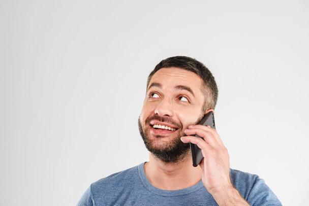 Cheerful man isolated talking by mobile phone. - Foto, imagen