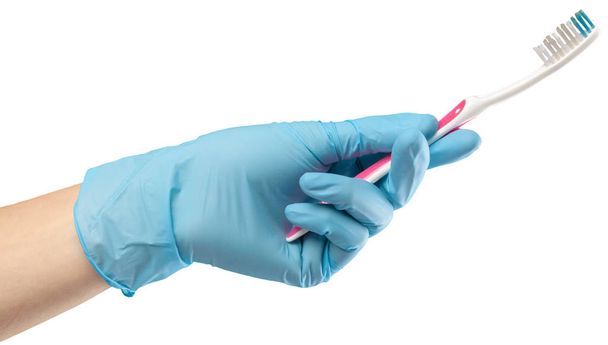 Toothbrush in the gloved hand - Photo, image