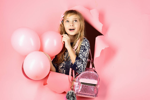 Birthday, happiness, childhood, look. Kid with balloons, birthday. Little girl with hairstyle hold balloons. Beauty and fashion, punchy pastels. Small girl child with party balloons, celebration. - Fotó, kép
