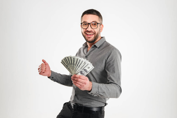Excited businessman holding money. - Foto, Imagem