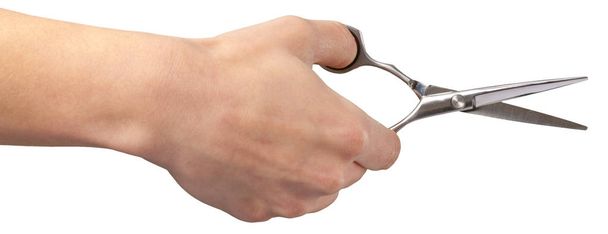 Human hand holding scissors over white background - Foto, Imagem