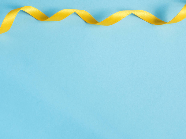 Holiday ribbon on blue background with copy space - Photo, Image
