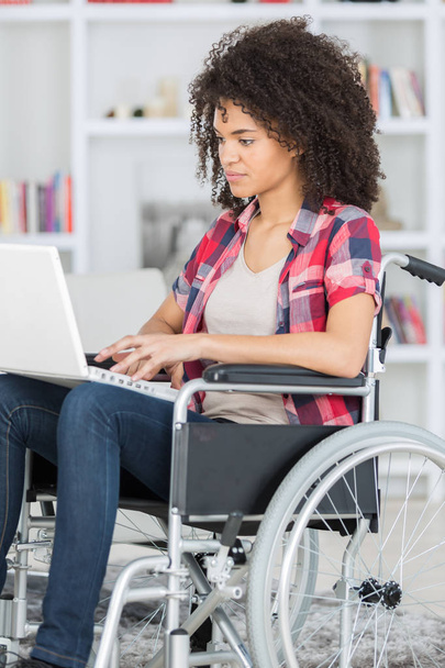 young girl on wheelchair surfing web - Zdjęcie, obraz